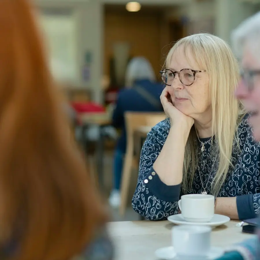 Woman listening over a cup of coffee