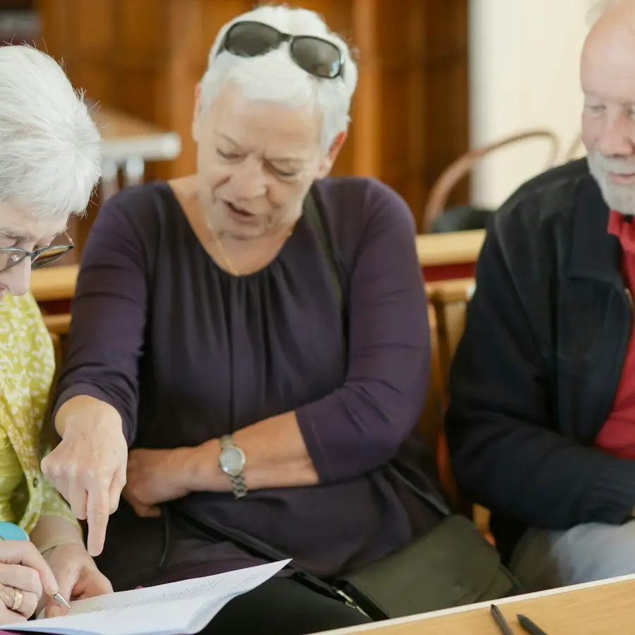 Three people looking at a paper together