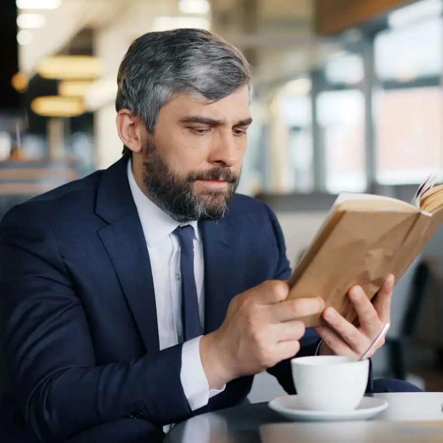 Man reading a book in a café