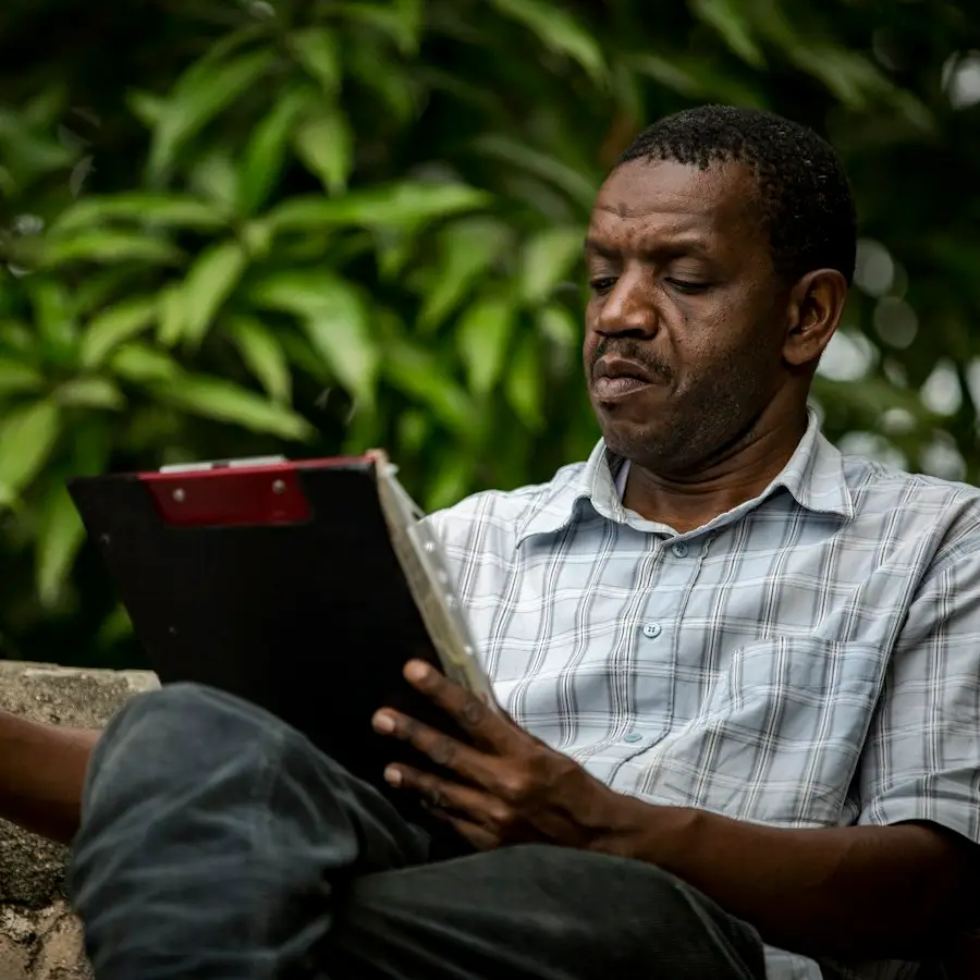 Man reading papers outdoors