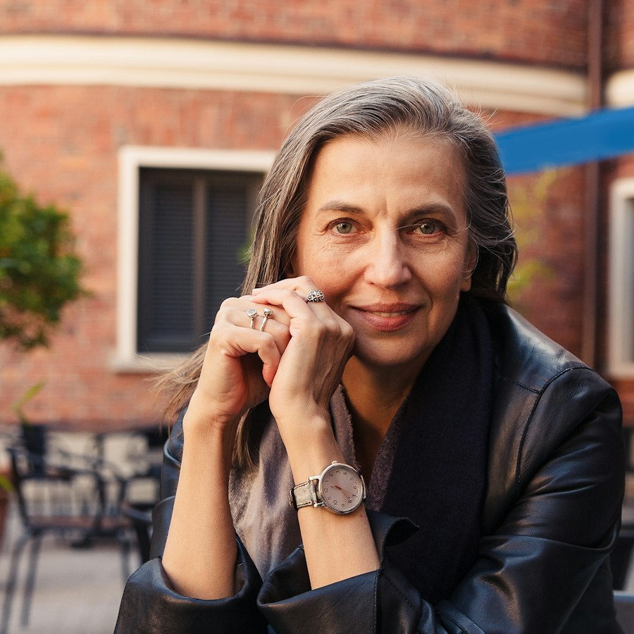 Woman smiling at an outdoor café table