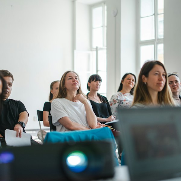 Adults listening at a workshop