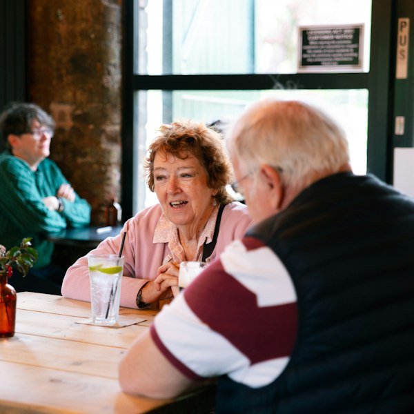 Two couples chatting in a café