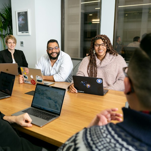 People round a meeting table