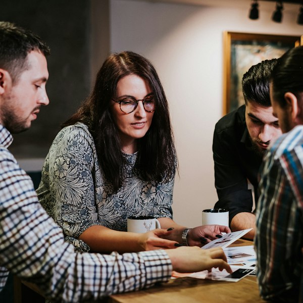 Four people reviewing documents together