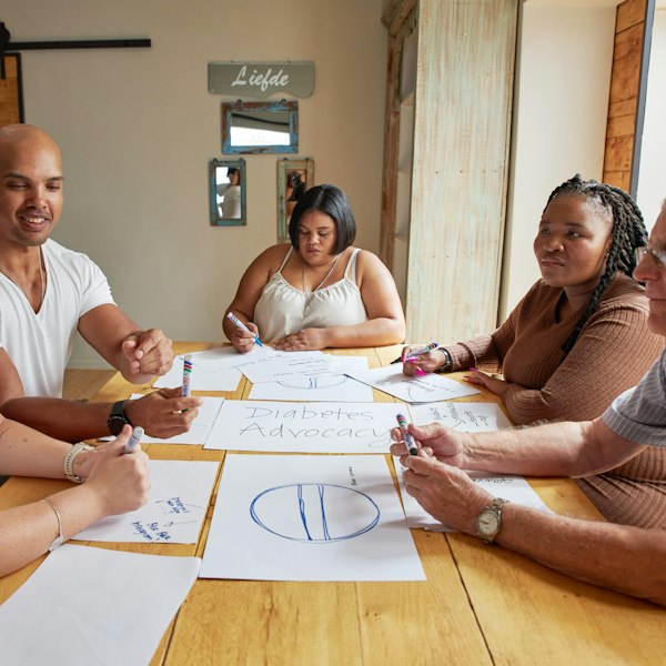 Mixed group discussing papers round a table